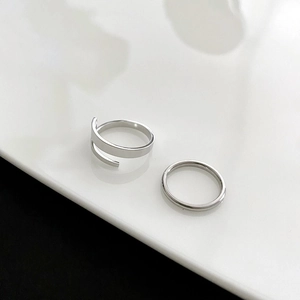 Detail of silver titanium steel rings set featuring spiral wrap and minimalist band