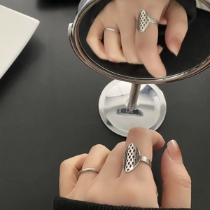 Hollow geometric silver ring set in stainless steel with 18k gold plating on model finger