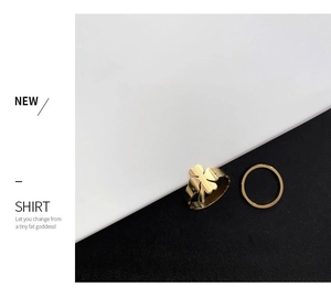 Detailed view of a gold four-leaf clover ring set with a minimalist slim band design