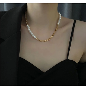 Detail of half pearl half golden Cuban chain necklace worn by a fashion model
