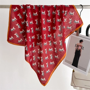 Detail of elegant dark red silk square scarf with dream horse print and orange rolled edges