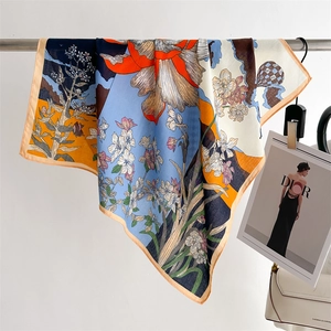 Detail of silk-like floral scarf draped over a rod, showing soft texture and fine hem
