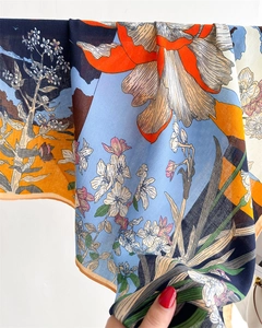 Detailed view of the woven herringbone texture and vibrant floral print on this silk scarf