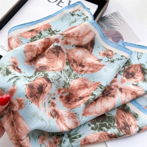 Light blue silk scarf with brown autumn leaf print and elegant herringbone texture