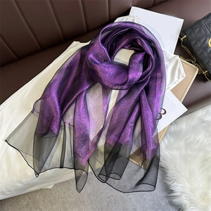 Close-up of purple shimmering scarf with black semi-transparent tulle edge detail