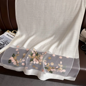 Detailed embroidery of pink begonia flowers on a beige silk and wool blend scarf