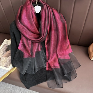 Detail of fuchsia gradient silk scarf with metallic shimmer and black mesh trim