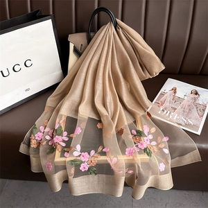 Detailed embroidery of pink begonia flowers and pearls on champagne silk scarf