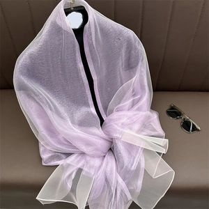Macro shot of breathable lavender silk blend shawl with subtle pearlescent finish