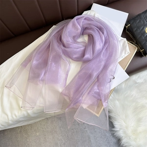 Macro detail of purple shimmering sheer scarf fabric with fine glitter metallic finish