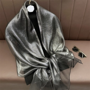 Silver metallic silk scarf detail featuring layered organza hem and shimmering texture