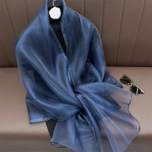 Detail of royal blue semi-transparent silk scarf shawl with sparkling glitter texture