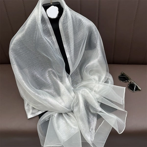 Detail of elegant silver silk scarf with a pearlescent sheen on a mannequin
