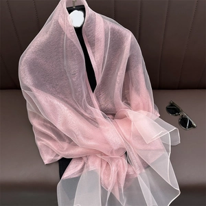 Detail of pink pearlescent silk scarf showing lightweight sheer fabric and soft texture