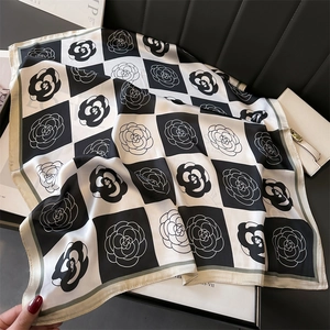 Elegant black and white camellia silk scarf with checkerboard pattern and green border