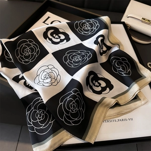 Detail of checkered camellia flower silk scarf with premium satin texture and beige borders