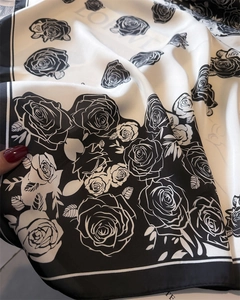 Detail of silk-like square scarf featuring vintage camellia patterns and border