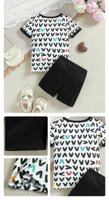Detail of baby boy summer cotton set showing ribbed cuffs and geometric print patterns