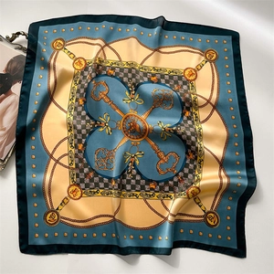 Detailed flat lay of a retro chain print silk square scarf with vintage key patterns