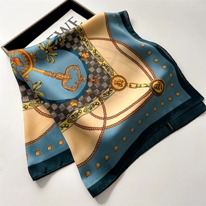 Detail of printed silk-like square scarf featuring classic chain patterns and houndstooth