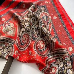Close-up of vintage red paisley silk scarf with white daisy floral print patterns