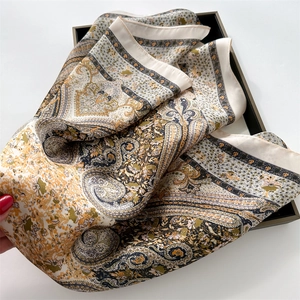 Detail of vintage paisley print silk scarf with floral patterns on a display tray