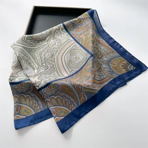 Vintage paisley print silk satin square scarf folded on a display tray for women