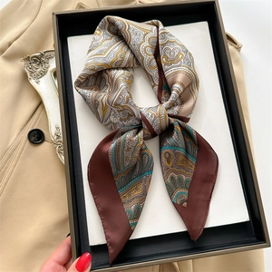 Detail of silk-like neckerchief with retro paisley pattern and polished satin texture