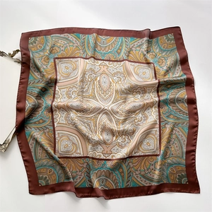Detail of vintage paisley pattern on a large square faux silk scarf with satin finish