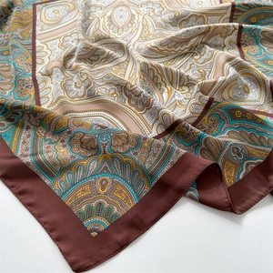 Close-up of silk-like paisley square scarf showing rich textures and detailed ethnic patterns
