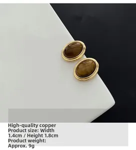 Detailed view of vintage oval tiger eye studs with copper frames and precise measurements