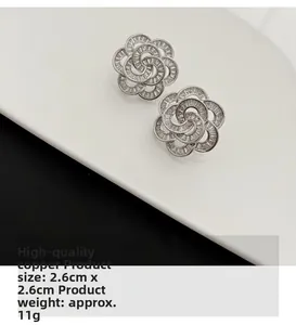 Detail view of silver rose earrings with crystals, size 2.6cm by 2.6cm, 11g weight