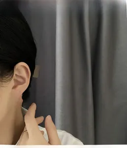 Detailed view of silver flower earrings with pavé zircons worn by a female model