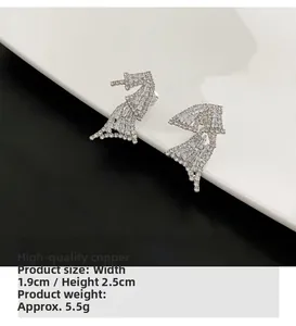 Detail view of butterfly earrings with white cubic zirconia and copper dimensions
