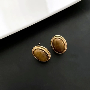 Vintage oval tiger eye stud earrings with polished gold metallic frame for women