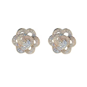 Elegant rose gold flower stud earrings with baguette-cut zircons on a white background