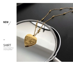 Detail of gold heart pendant with I Love You engraving on a beaded necklace chain