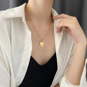 Golden heart necklace for women with I Love You engraving on a dainty beaded chain