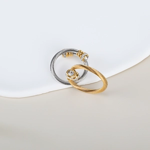 Detailed view of twisted cable rings with central round diamond and halo setting