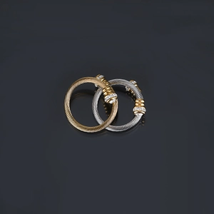 Macro view of gold and silver cable twist rings with sparkling white crystal accents