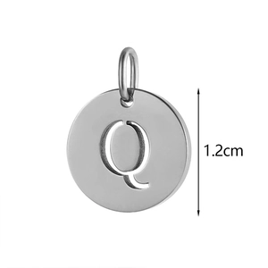 Macro detail of 12mm stainless steel circular pendant with cutout letter Q design