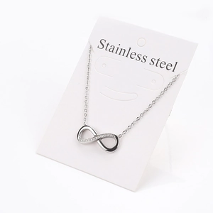 Close-up of infinity symbol pendant necklace with zircons on stainless steel chain