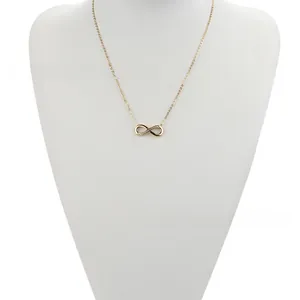 Detailed view of infinity pendant with 18k gold plating and shimmering zircons