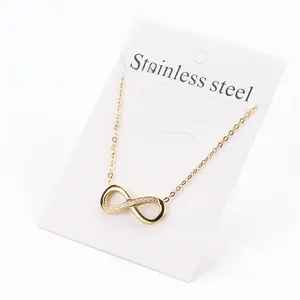 Macro shot of 18k gold plated infinity pendant with cubic zirconia on display card