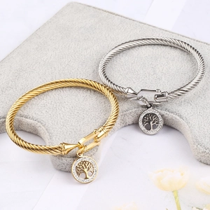 Macro detail of Tree of Life pendants on twisted rope bracelets with crystal accents