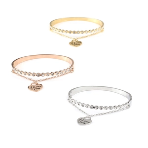 Close-up of three-tone steel bangles with cubic zirconia and heart charms