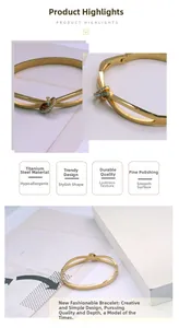 Détail du bracelet croisé en acier titane doré en forme de C avec cristaux incrustés