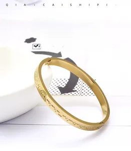 Detail of gold titanium steel bracelet featuring heartbeat engraving and small zircon stones