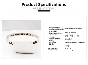 Detailed view of stainless steel cuff bracelet with heart detail and inspirational engraving