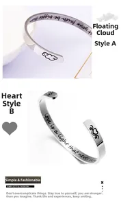 Macro shot of silver stainless steel cuff bracelets with inspirational engraved messages